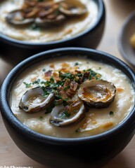 Creamy clam chowder in bowls, garnished, on a table