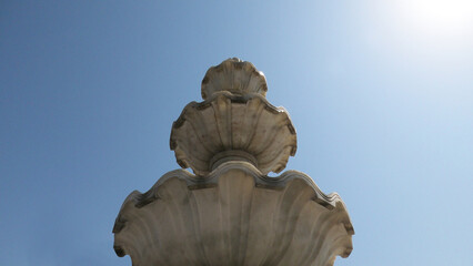 Elegant white marble sculpture with decorated curves