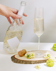 Sparkling drink preparation with floral accents on a table