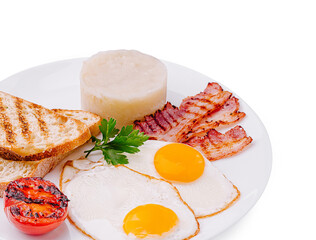 Breakfast plate with eggs, bacon, toast, and tomato served hot