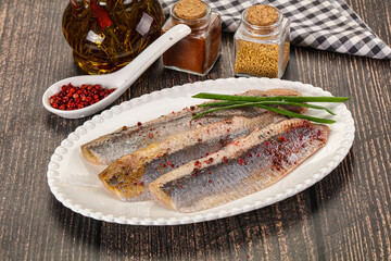 Salted marinated herring fillet with spices