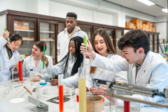 University students conducting chemistry experiment in lab
