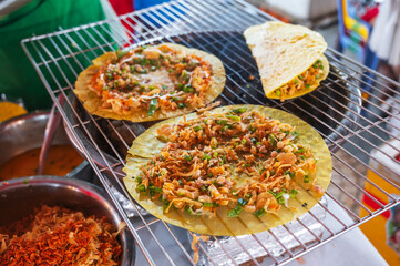 Vietnamese banh Xeo pancakes grilled at an Asian street night market in Vietnam. Traditional Vietnamese street food
