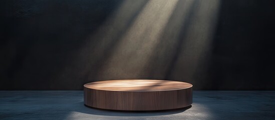 Circular wooden podium in a dimly lit room, illuminated by beams of soft light, positioned centrally against a dark textured wall.