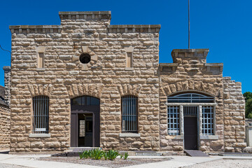 This stunning historic stone building captures the essence of architecture from previous eras, showcasing its rich history and unique textured surface.