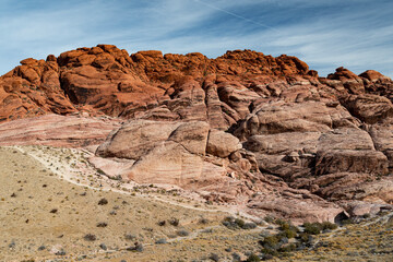 The vivid red hues of rock formations showcase nature's artistic grandeur, with layering and texture highlighting the beauty and timelessness of geological diversity.