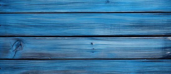 Obraz premium Blue wooden planks background with smooth texture and varying shades of deep blue and light blue arranged horizontally across the image.