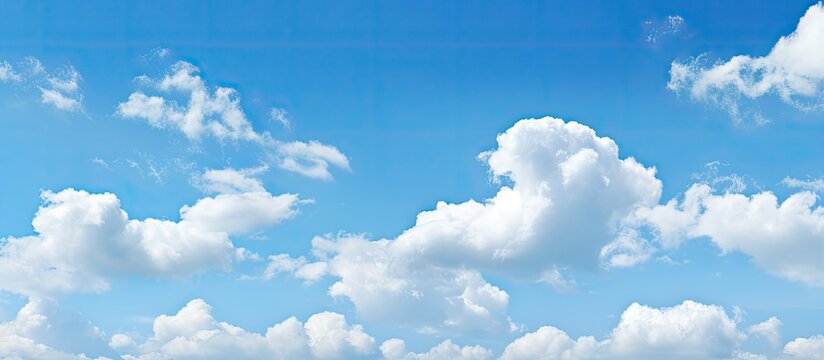 Vibrant blue sky with soft white cirrocumulus clouds scattered throughout the upper frame creating a serene and tranquil atmosphere