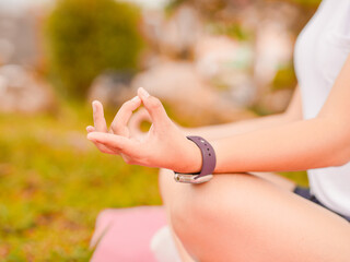 Wellness lifestyle Health. woman meditating under tree with nature in a park during a holiday. People mindfulness to care for their mental health, wellbeing, happiness yoga pose. 