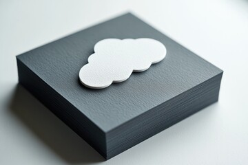 A white cloud-shaped object rests atop a dark gray textured block.
