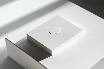 Stack of textured white cards with embossed cloud, minimalist design.