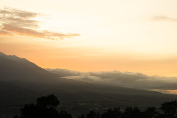 Fototapeta premium Mountain Sunset with Misty Layers