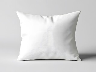 A square white pillow is resting on a white surface