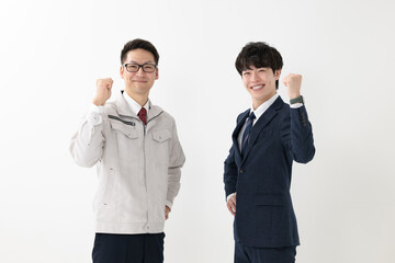 作業着を着た男性とビジネスマン
