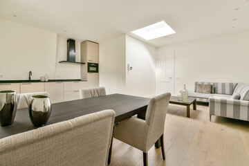 A contemporary living area featuring a sleek dining table and stylish furnishings, illuminated by...