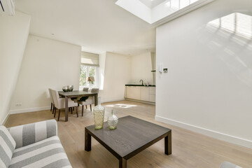 Bright and airy modern interior design featuring a dining area with sleek furniture and a minimalist kitchen. natural light enhances the spacious feel.