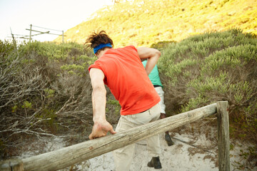 Jump, outdoor or man climbing obstacles for strength, endurance exercise or bootcamp challenge. Military course, people or wooden barrier in physical test for workout, fitness or training assessment