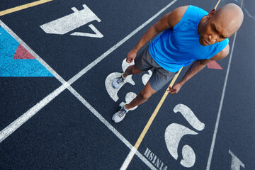 Black man, fitness and runner with track at stadium for race, sprint or sport marathon above. Top...