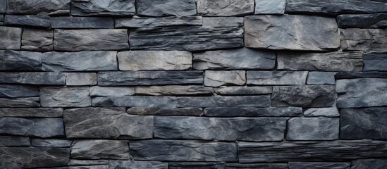 Textured gray stone wall background with varying shades of gray, featuring stacked rectangular stones arranged in a uniform pattern.