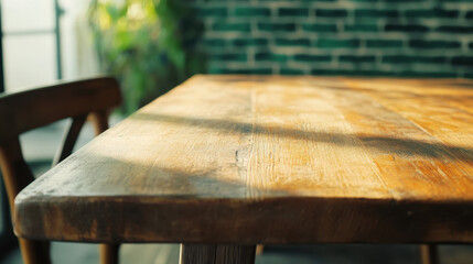 Fototapeta premium close up shot of rustic wooden table with natural light casting shadows, creating warm and inviting atmosphere in cozy restaurant setting