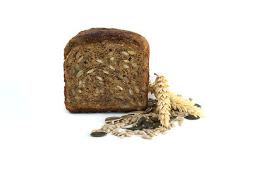 A nutritious slice of multigrain bread featuring an array of seeds and a single sprig of wheat.