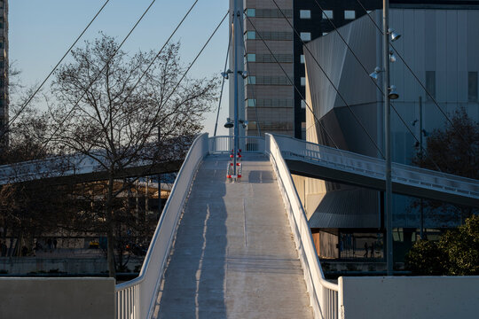 Minimalist pedestrian bridge with sleek lines and a futuristic design.