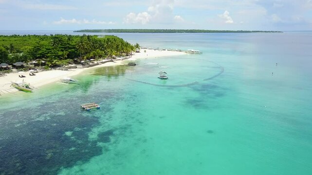 Zoom out of the white sand beach in the tourist area of ​​the Virgin island in the Bantayan region, Phillipines.