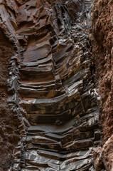 Close-up of a jagged rock formation with layered geological patterns in earthy tones