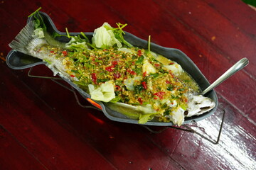 Steamed sea bass with lemon in a fish-shaped tray
