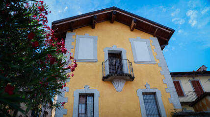 Exploring Isola Superiores charming yellow building under a clear sky in Italy