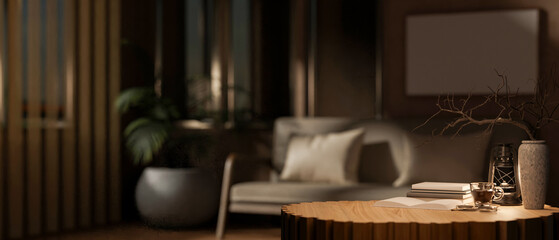 The round wooden table with decors in the middle, with blurry background of dark living room.