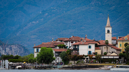 Fototapeta premium Charming Isola Superiore village with green mountains in northern Italy during daytime