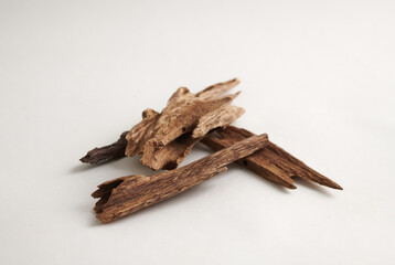 Macro Shot of Agarwood Chips isolated on white background– Rare and Aromatic Wood