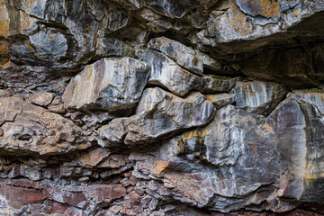 A close-up of an intricate rock formation revealing vibrant colors and textures, showcasing nature's artistry in geological layers and evoking a sense of wonder and exploration.