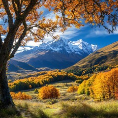 Naklejka premium Autumn colored trees with mountains and snow in a valley