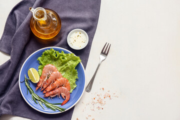 Plate with tasty boiled shrimps lettuce, lime and rosemary on white background