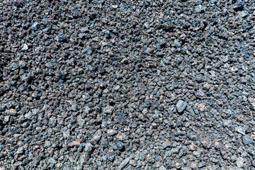 An abstract close-up image showing the intricate texture of volcanic lava rock, highlighting the raw beauty and geological significance of natural formations.