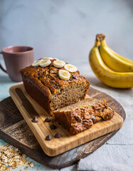 Moist Banana Oatmeal Bread with Chocolate Chips on a Wooden Board