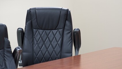 Black leather office chair at a conference table