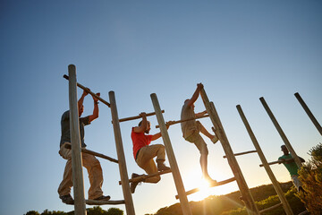Climbing, effort and obstacle course with military men outdoor on blue sky for challenge or training. Army, drill and exercise with group of people at base for fitness, team building or workout