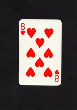 A hearts playing card isolated on a black background.