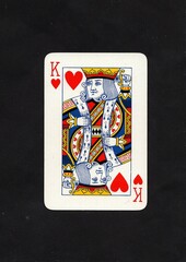 A hearts playing card isolated on a black background.