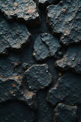 Dark, rough-hewn stone; deep crevices, earthy tones, earth, basalt