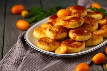 Cheesecakes with delicious kumquats and citrus jam, close-up