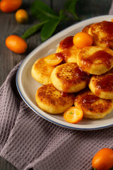Delicious cheesecakes with kumquats and citrus jam, close-up