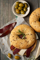 Burger with basturma, olives and rosemary, top view