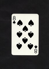 A spades playing card isolated on a black background.