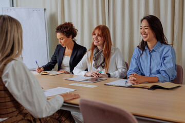 Businesswomen holding an interview in the glass office