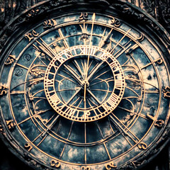 Fototapeta premium A close-up shot of a vintage clock face with Roman numerals, detailed metal hands, and a rich golden finish, capturing the classic elegance and timeless design of an antique timepiece.