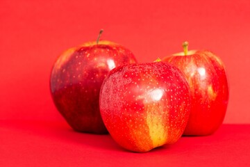 Bright red apples isolated on a bold colorful surface